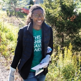 A photo shows Courtney Streett '09 walking in the Edible Ecosystem on the Wellesley campus.
